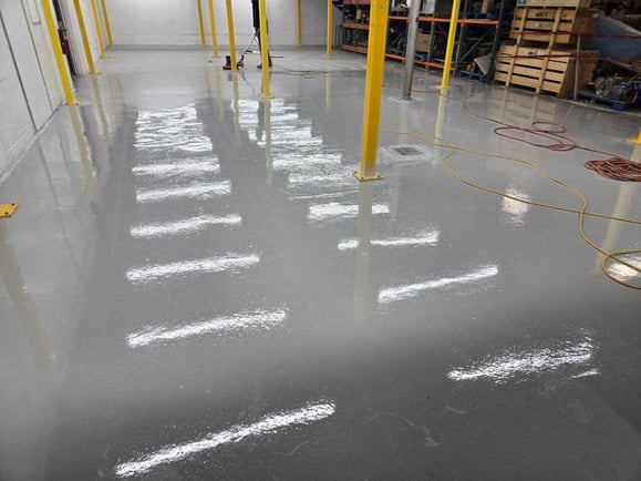 Epoxy floor coating in an industrial warehouse. 