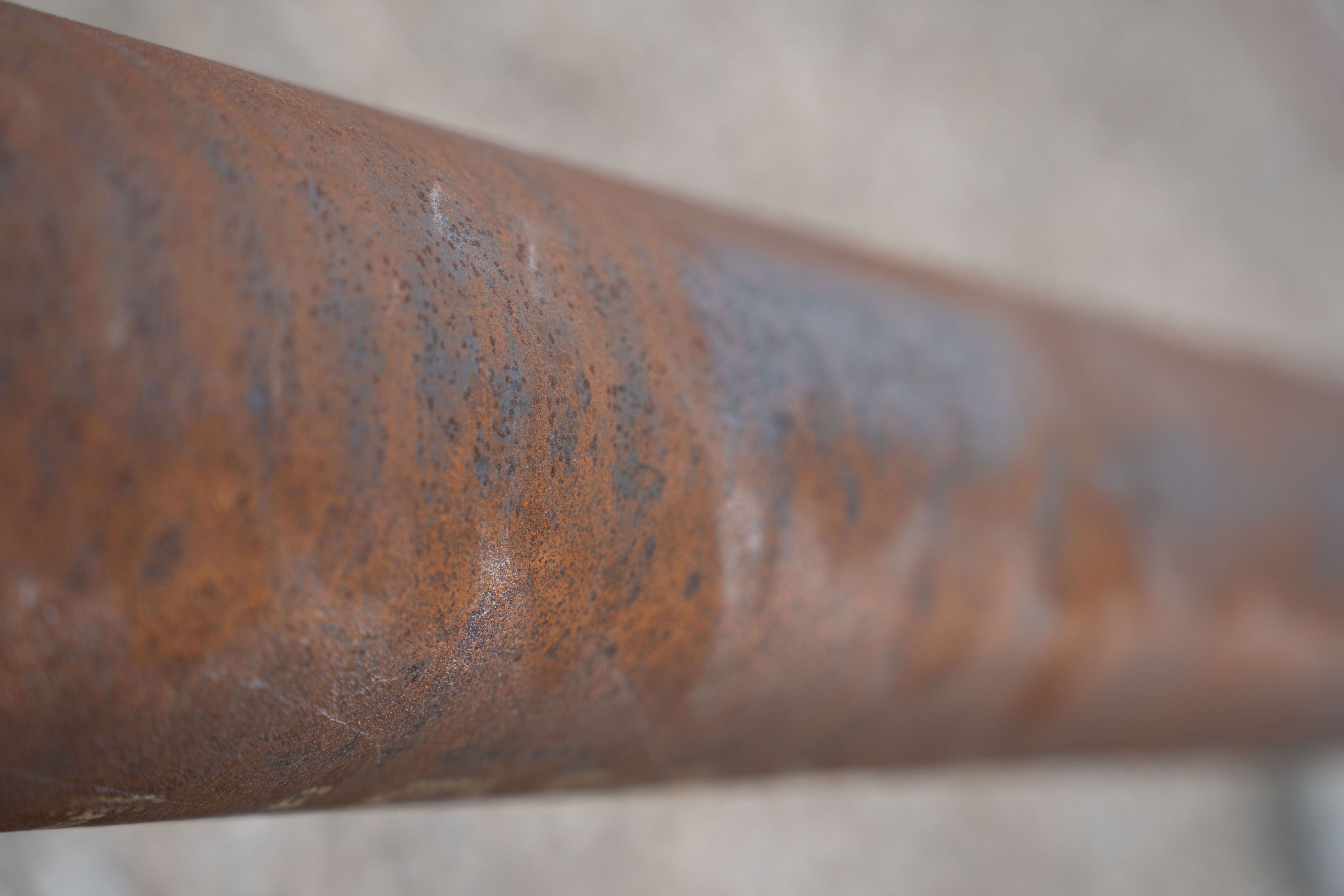 failing and rusted industrial pipe coating that needs a new coating