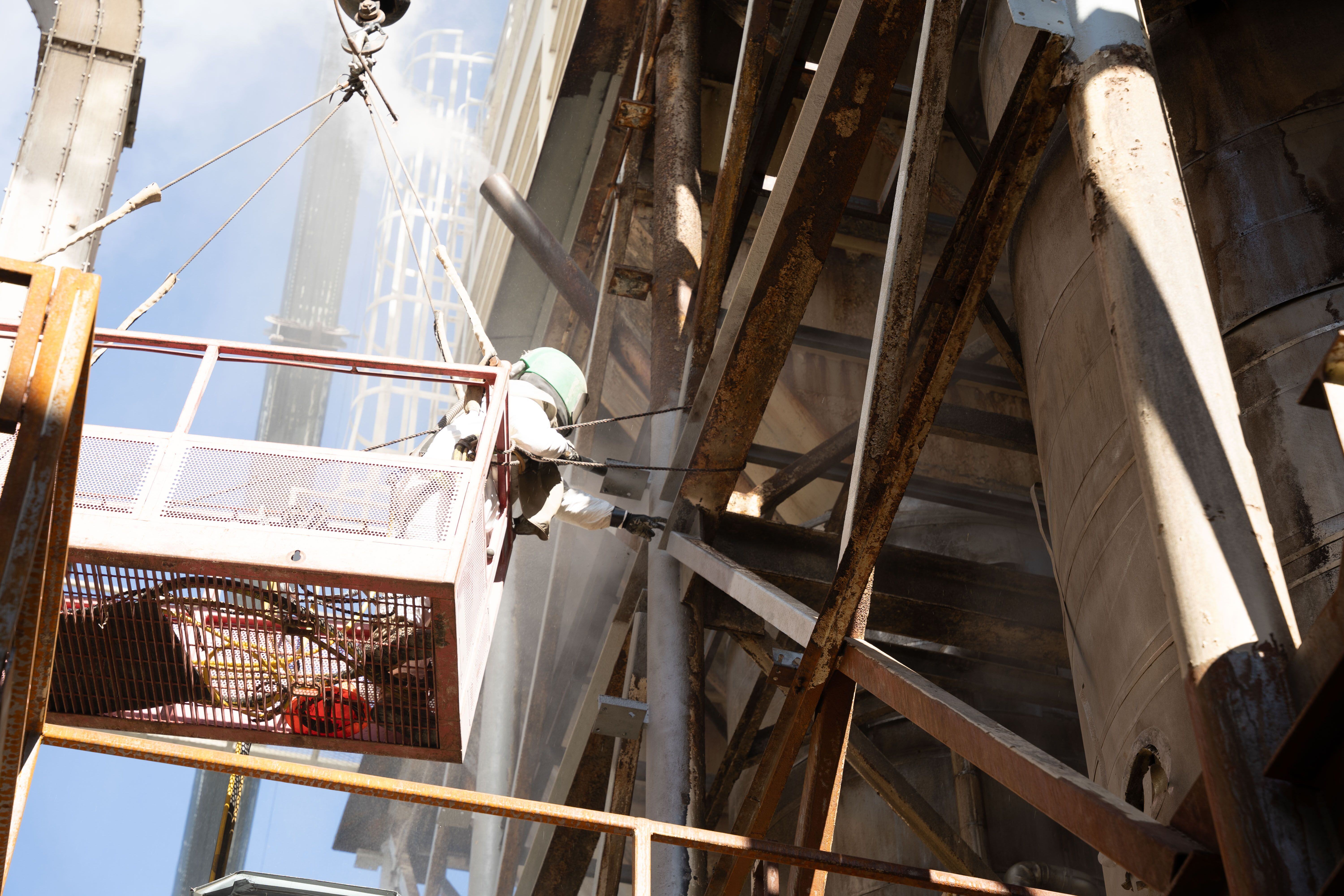 industrial coatings being applied on the exterior of a production facility