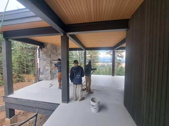 men working on the deck floors of a house