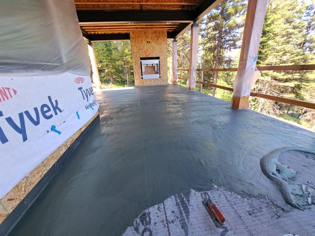 deck is being worked on outside the house and floor is protected