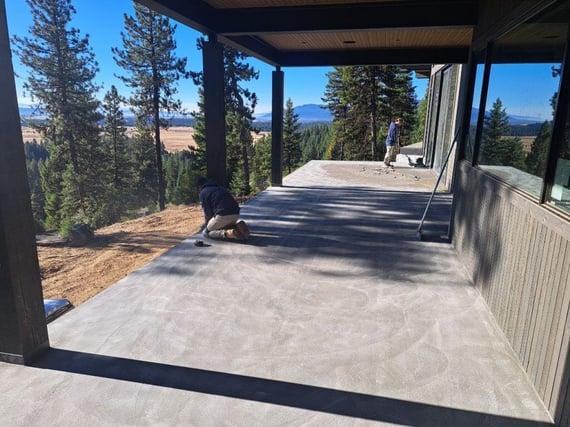 a beautiful deck with trees and a view of mountains in the background