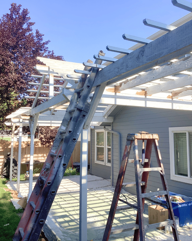 exterior painting project in process of a backyard pergola