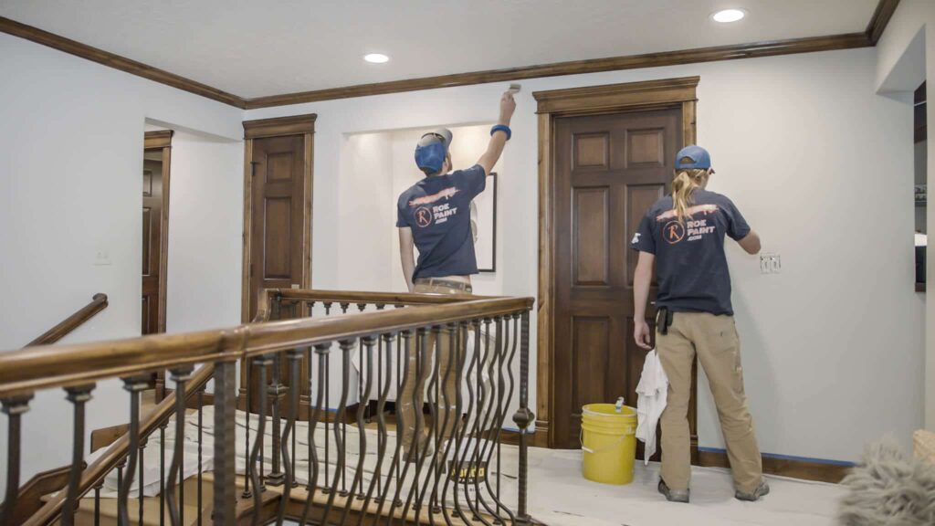 Two Roe Painters painting in the hallway