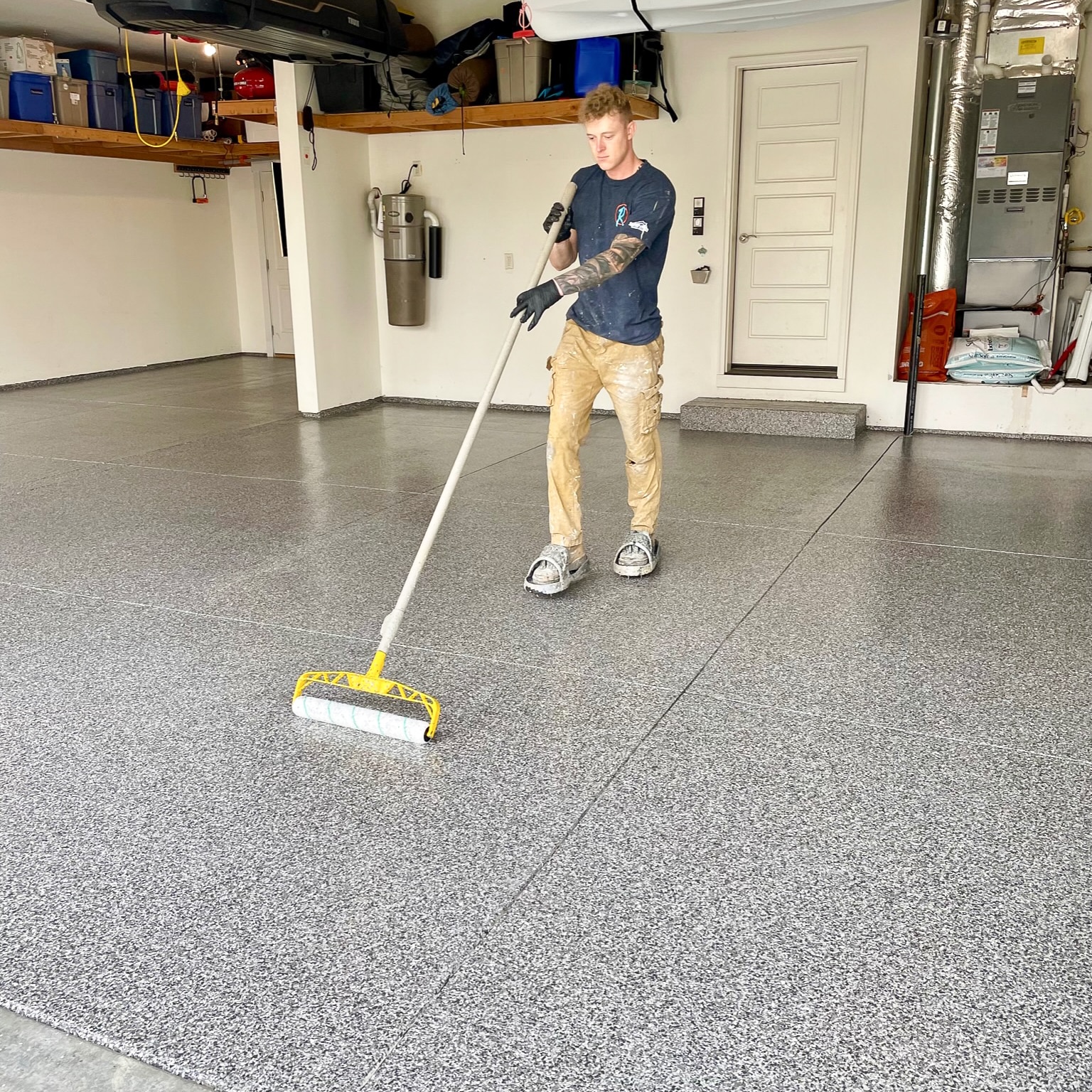Roe Painting Employee Applying A Flakey Concrete Coating System To A Concrete Floor